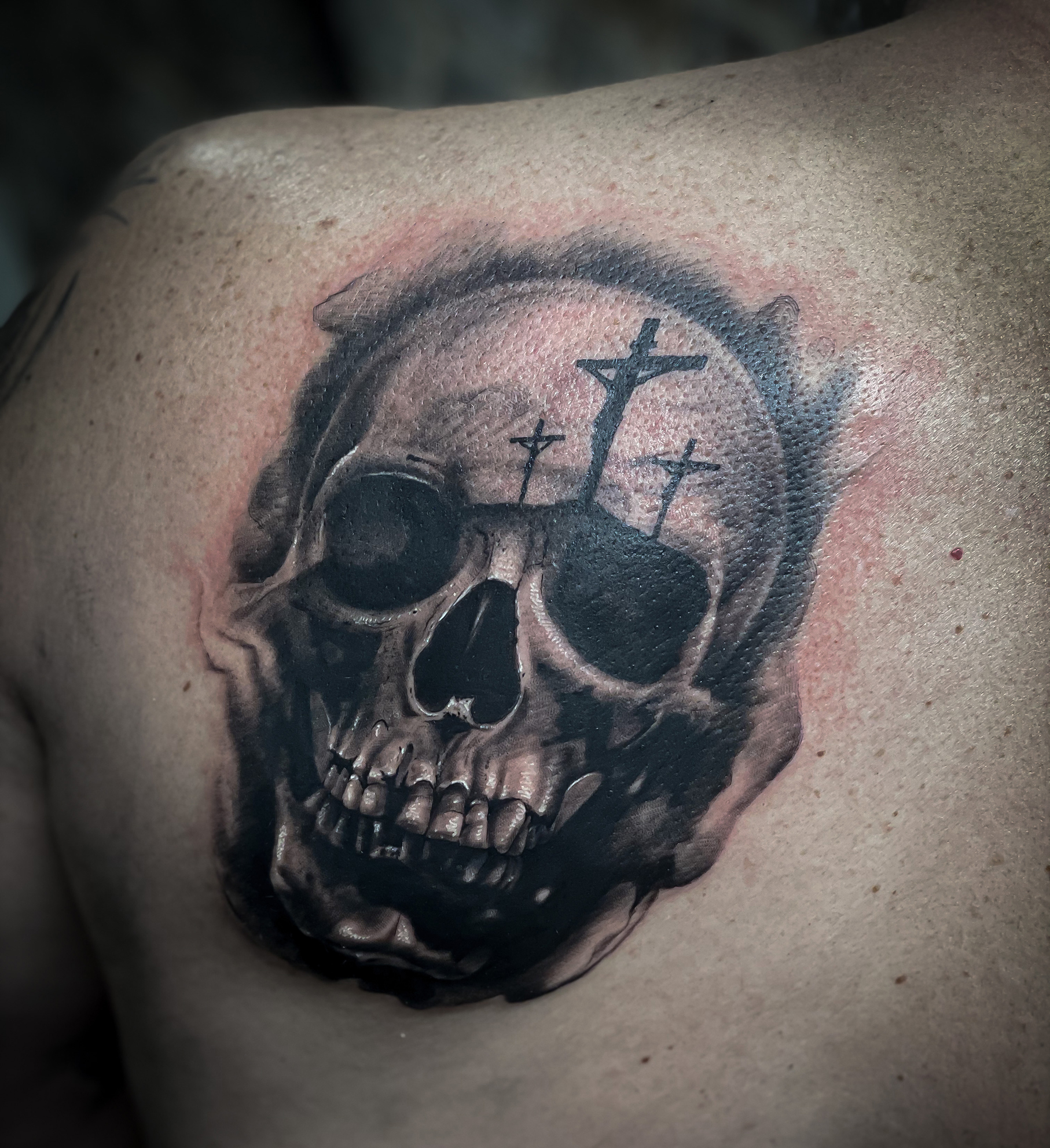 Grey shaded bullet holes punisher skull tattoo on left upper sleeve for men